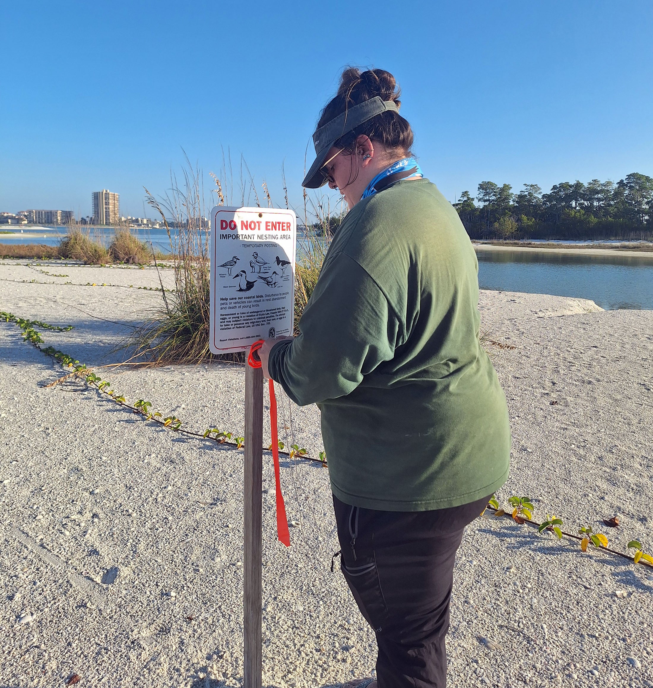 A person with a sign on a beach